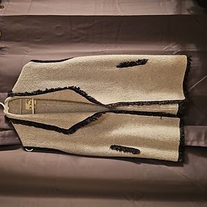 Long sweater vest with frayed trim. Size large.